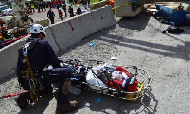 A mine rescue worker secures a patient for safe transport