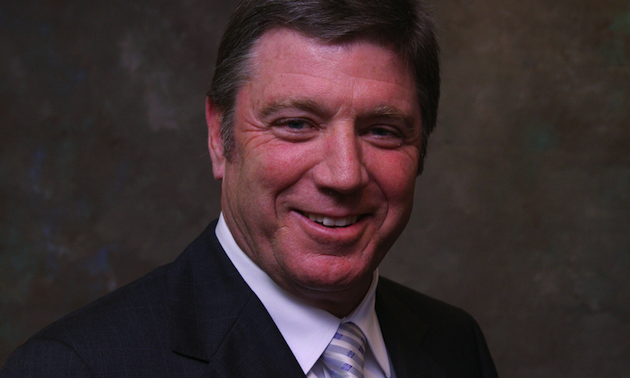 White male wearing suit and tie.