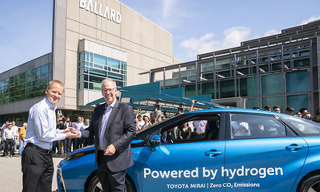 Stephen Beatty (right), Vice President, Corporate, Toyota Canada Inc. provides Randy MacEwen, President and CEO of Ballard Power Systems with keys to a new fuel cell Toyota Mirai. 
