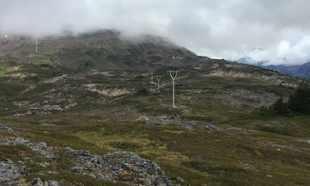 Completing the Brucejack transmission towers ranks as one of Alicia Du's proudest moments. The photo shows the transmission line crossing rocky terrain.