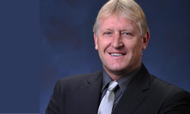 smiling man with suit and tie