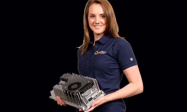 Picture of female Delta-Q employee holding battery charger. 
