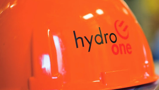 Picture of orange hard hat with the words 'Hydro One' written on it. 