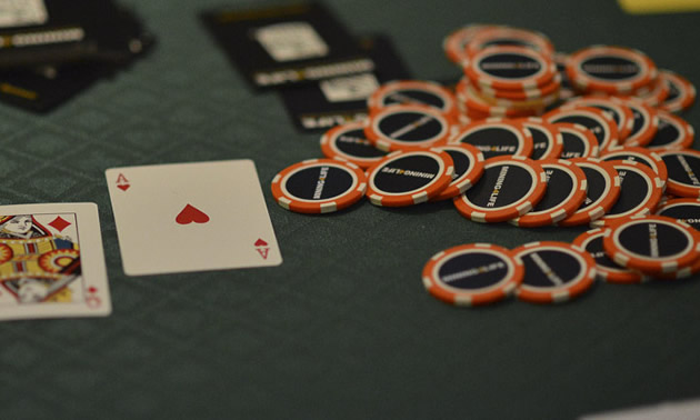 poker chips and playing cards on a table