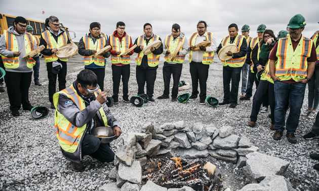 Feeding the fire ceremony during the 20th Anniversary at the Ekati Mine.