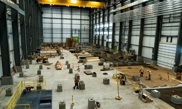 Inside the Concentrator building, showing large open area with workers. 