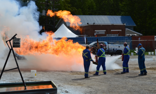 Miners douse a fire with fire extinguishers
