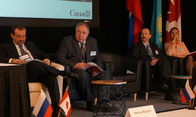 men in suits presenting at a conference