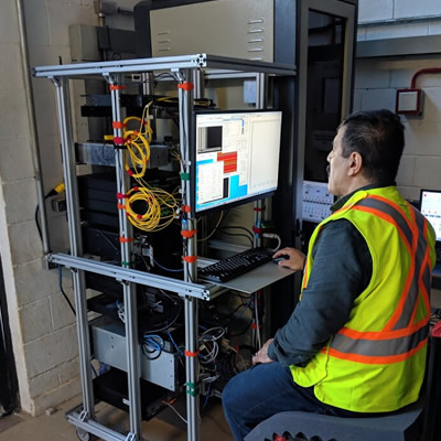 Hifi Engineering employee operating optical computing platform. 