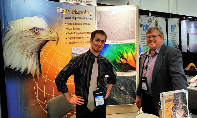 Two men posing for the camera. 