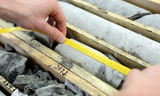 person measuring mineral structures