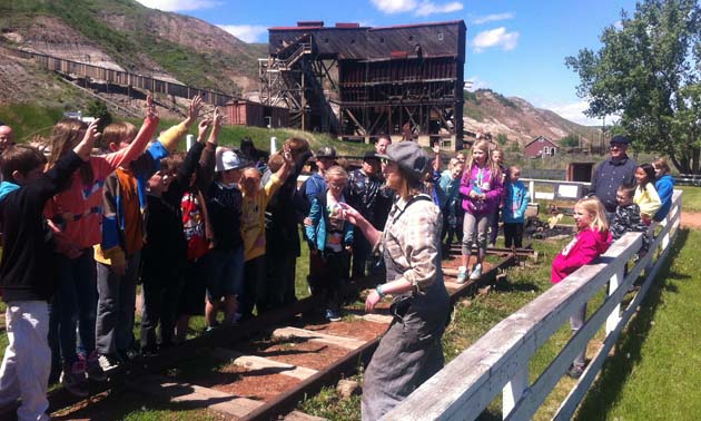 Emily guides kids through a train tour at Atlas Coal Mine.