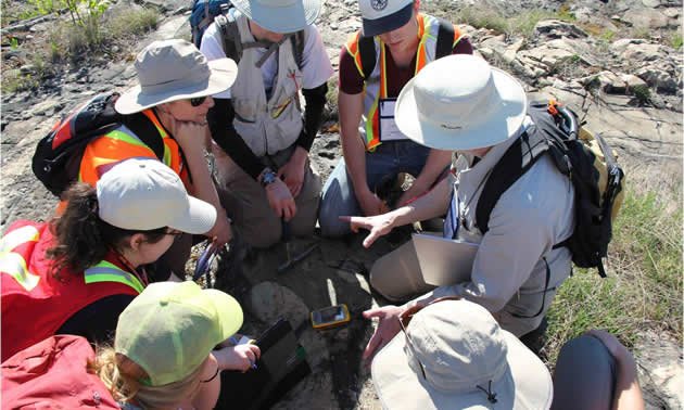 a group of students gathered in a circle outside